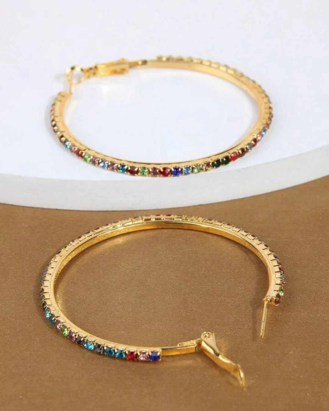 Colorful rhinestones embedded on golden hoop earring. 3 cms diameter